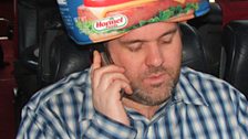 Chris wears the Spam hat while on the phone to Gwen Stefani.