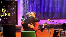 Man hugs with Gary Barlow