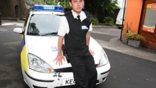 Here's PC Mills sitting on his car and ready to spring into action with his baton at any moment...