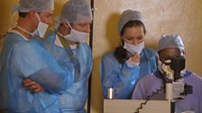 Scott, Dermot O'Leary and Kara Tointon watch a cataract operation at the health centre at Arsim, Kenya