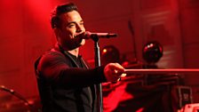 Robbie Williams performing live