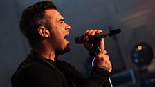 Robbie Williams performing live