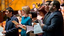 Members of the Carols For Christmas presenting and reading team on stage