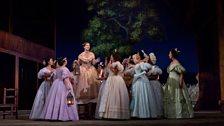 Anne-Carolyn Bird (on platform) as Giannetta in Donizetti’s “L’Elisir d’Amore.”