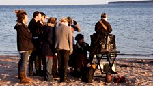 The crew look over some shots from the title sequence