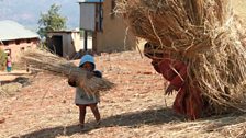 Children carrying sticks