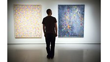 Visitor looks at the work Dancers on a Plane (1979) by Jasper Johns