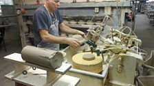 Slapping a piece of clay into shape