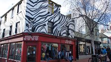 'You know. By the shop that looks like a zebra. By the chippie.'