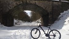 Taking a rest with the bike at a bridge