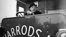 Sir John Betjeman, enjoying the delights of a 1919 Harrods delivery van