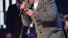 Suggs performing with Madness