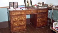 Henry Handel Richardson's writing desk, displaying her portrait by Rupert Bunny