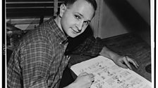 Jules Feiffer, American cartoonist and writer of Carnal Knowledge, seated at work on cartoon