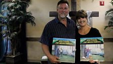 Siblings Cherri and Randy Meeks with a copy of their family Album