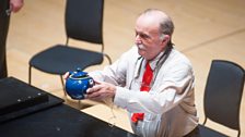 Alvin Lucier displays an amplified teapot at the world premiere of Nothing is Real, at the Tectonics