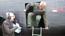 Back on solid ground after his flight in a Lancaster Bomber Chris Evans is greeted by Jeremy