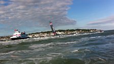 Sir Ben Ainslie passes the finish line on his AC45