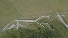 The Bronge Age White Horse of Uffington, carved from the hillside and filled with chalk