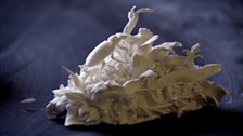 Close-up look: A small, white porcelain piece of natural scene