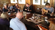 Musicians gather to play folk music in a pub in Perranporth, Cornwall