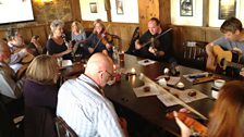 Musicians gather to play folk music in a pub in Perranporth