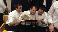 Ultra-orthodox yeshiva students studying the Talmud by debating and arguing over its texts and laws