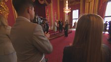 Aleem and Saffron watch the Queen in an awards ceremony