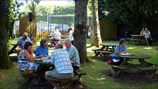 Customers enjoy the sun in the garden