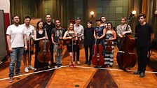 The xx pose with their orchestra