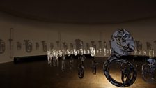 Cornelia Parker, Perpetual Canon, 2004; flattened brass band instruments suspended.