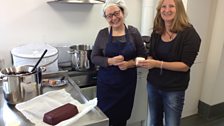 Lizzie Smith and Caz Graham, with a block of damson cheese.