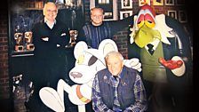 Brian Cosgrove, David Jason and Mark Hall (kneeling) with cut-outs of Danger Mouse and Count Duckula’s butler Egor in 2001