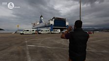 Fazeel Ahmed takes a picture as the convoy arrives in Greece