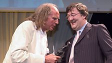 John Tavener receiving the Ivor Novello Award from Stephen Fry for Achievement in Classical Music in 2005.