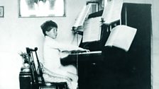 Benjamin Britten playing the piano at home in 1921