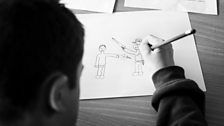 A school pupil works on a picture during a FARE anti gangs workshop.