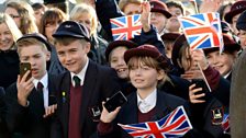 Children from Salisbury wave and cheer