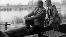 Peter Scott and David David Attenborough looking surveying a lake at WWT Slimbridge