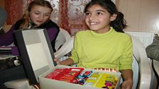 Yana opens her shoebox