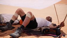 James Cracknell sleeping under a sun shade in the heat of the day.