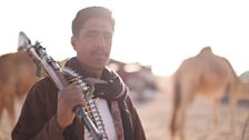 Bedouin tribesman with gun at the temporary training camp on edge of the Empty Quarter.