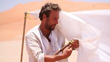 Ben Fogle setting up a sun shade.