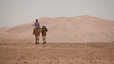 Ben Fogle riding camel in the distance.