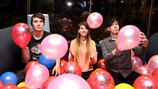 BANG! Dan, Phil and Zoe in the pool of balloons.