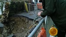 Tony Couchman Chair of Lower Kelly Residents Association, looks into the hole left by the landslide