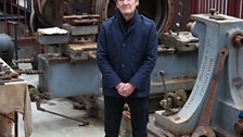 Presenter David Hayman surrounded by machinery