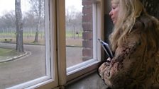 Rev Ruth Scott looking out of window of Barrack Blocks in Auschwitz 1.