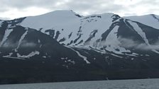 Iceland's snow capped mountains across the bay from Husavik.