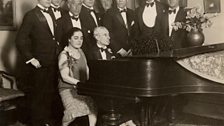 Ravel at the piano, during his American tour. At far right is George Gershwin.